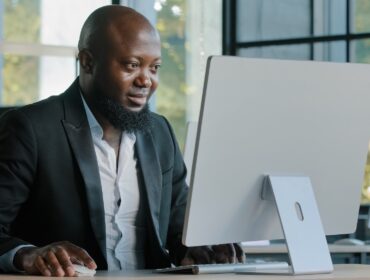 African american businessman commercial agent expert site in modern office work on computer develop